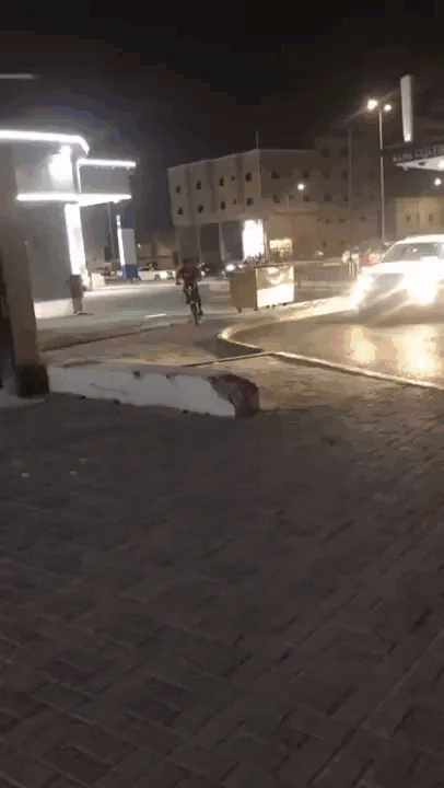 Boy doing a 180 drift on a comically long bike with a swastika printed on the side